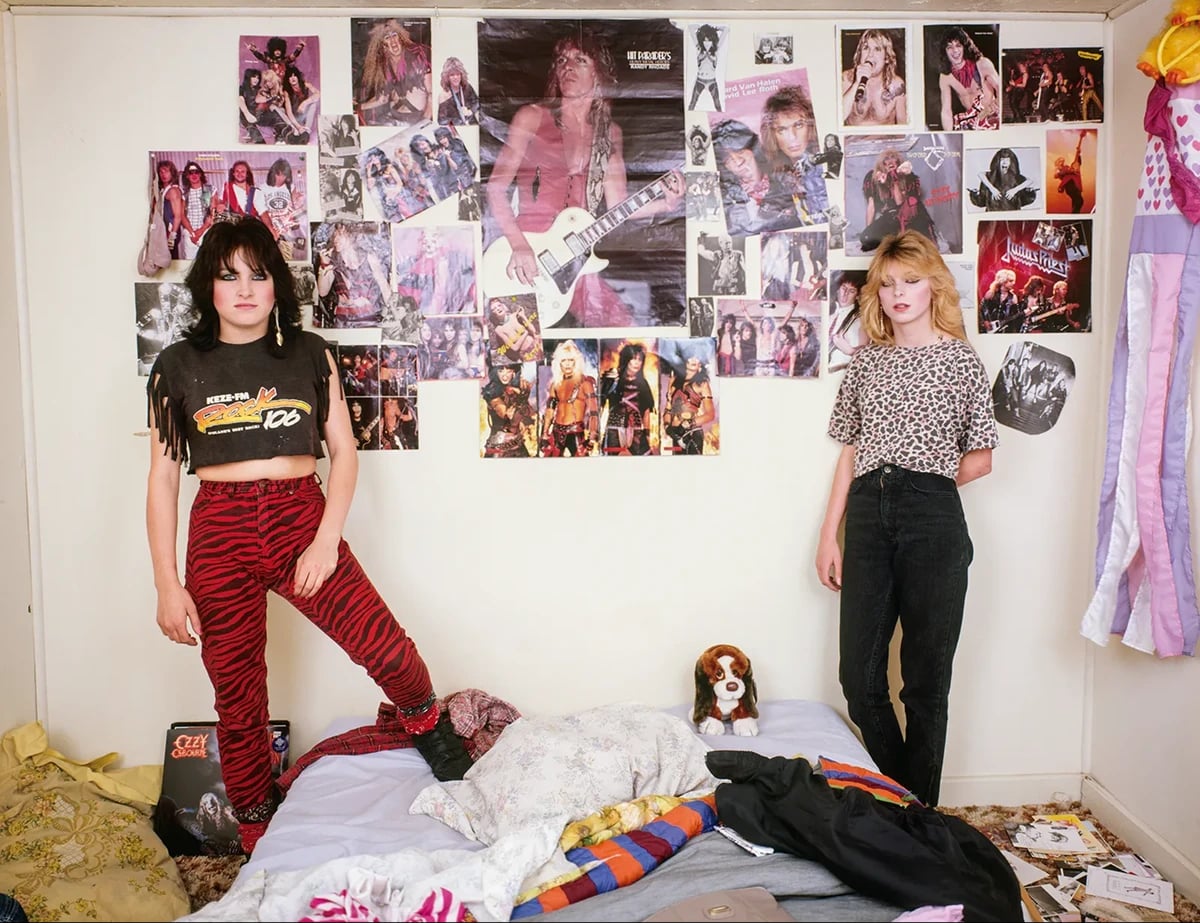 Teenage girls standing in a messy bedroom covered with rock band posters, photographed by Adrienne Salinger in the 1990s.